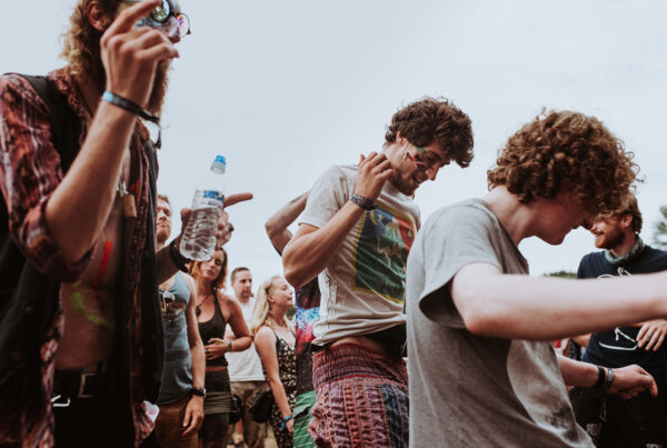 Young people dancing at outdoor music festival