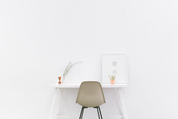 Minimal white desk, chair, plant, framed art