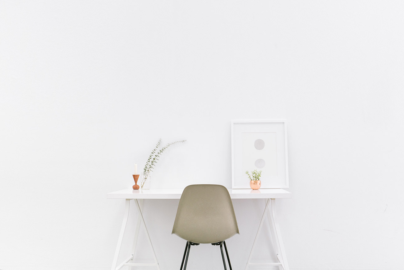 Minimal white desk, chair, plant, framed art